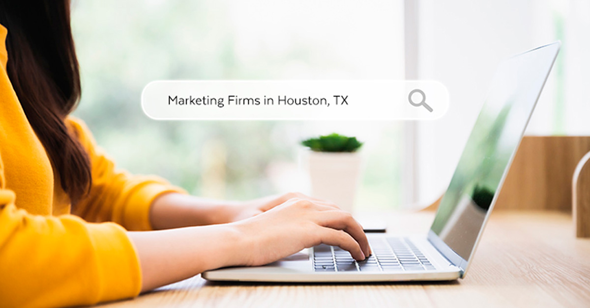 A woman searching for marketing firms in Houston, Texas on her laptop.