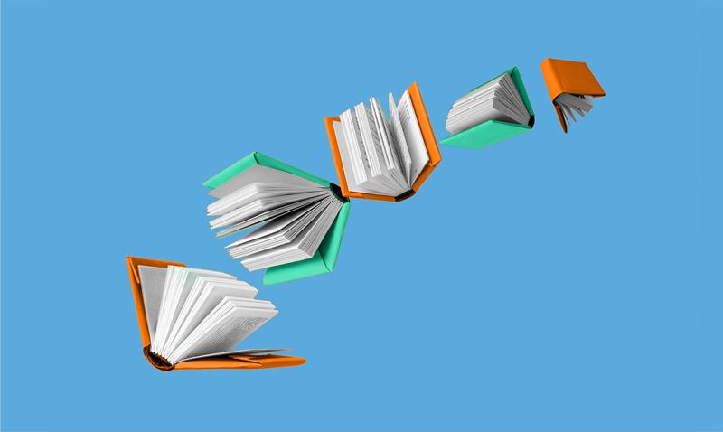 Books with teal and gold covers flying through the air.