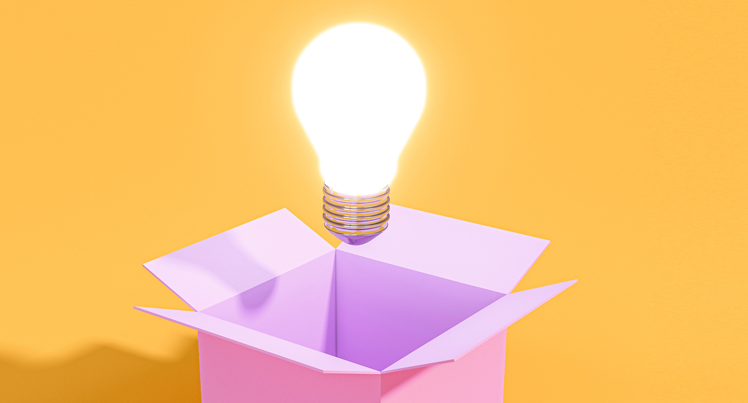 A light bulb emerging from a box, representing the ability of a marketing agency to think creatively.