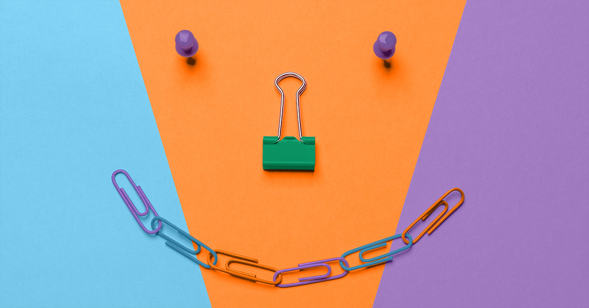Paperclips, alligator clip and push pins in the shape of a smile.