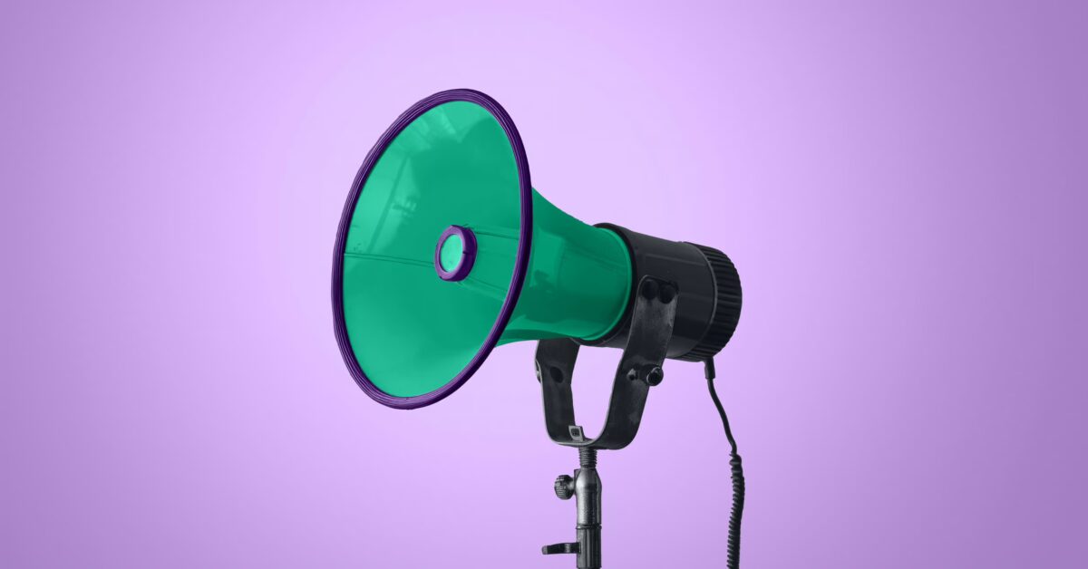 Green megaphone on purple background showing message amplification from the How Email Newsletters Nurture Leads and Amplify Your Influence article by Design At Work