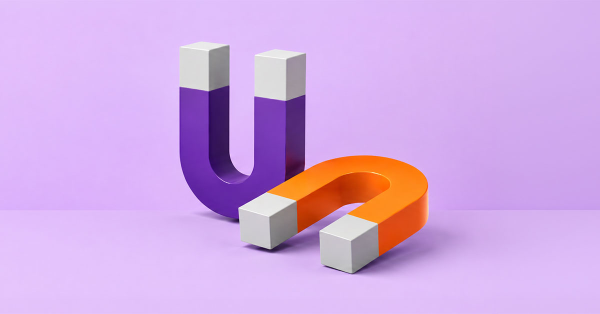Purple and orange U-shaped magnets on lilac background
